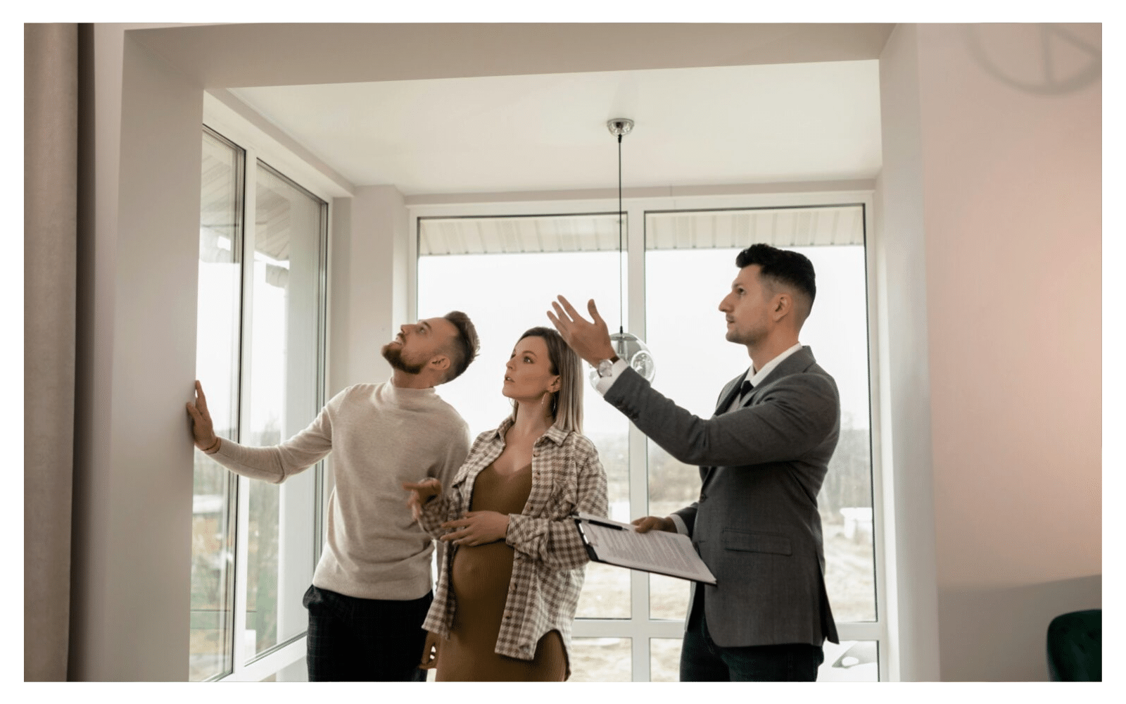A property specialist showing a couple a home